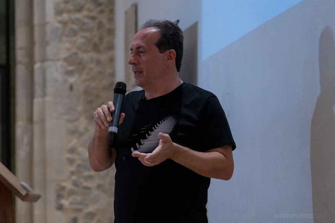 Neil Douek speaking on stage